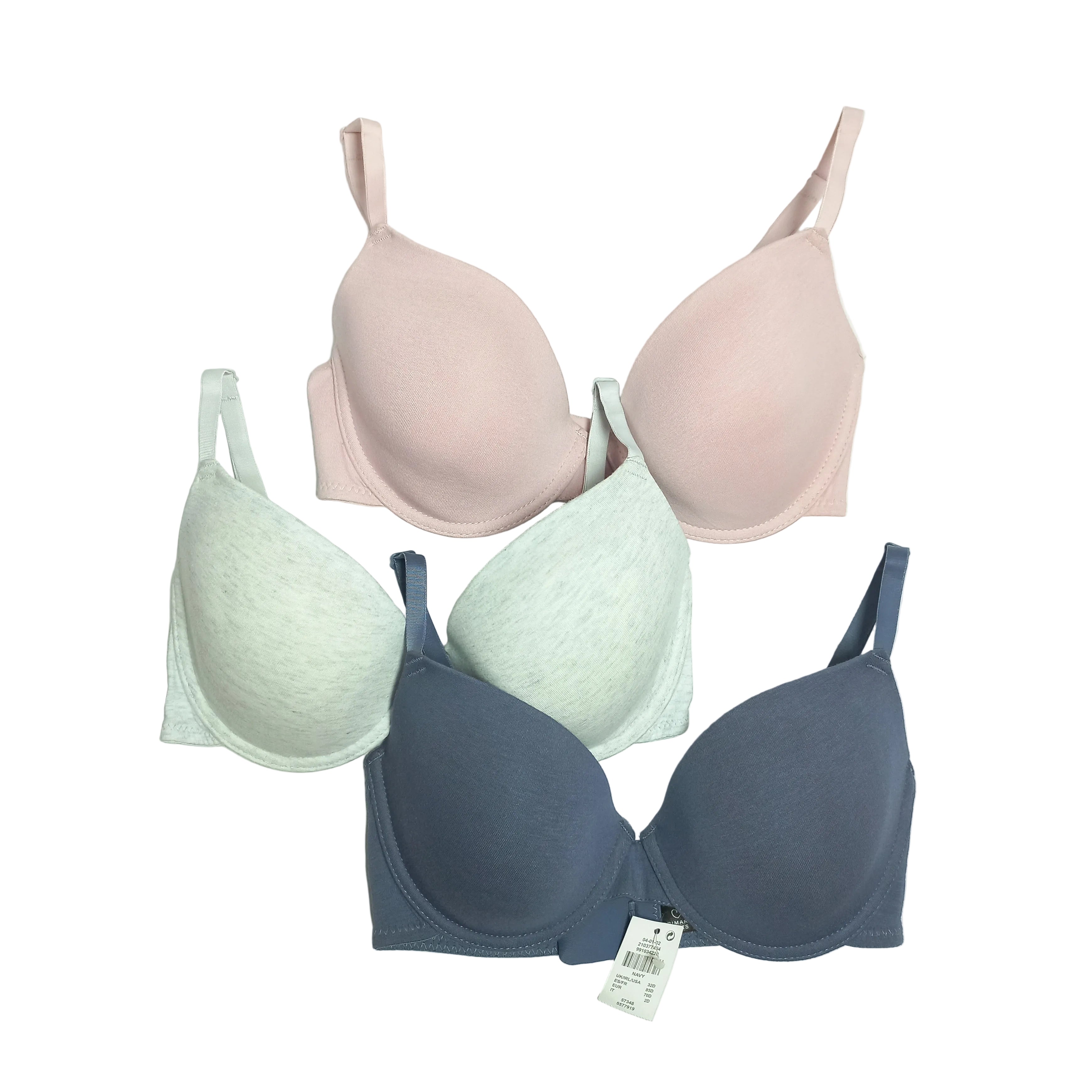 Set of three bras in pink, green, and blue on a white background