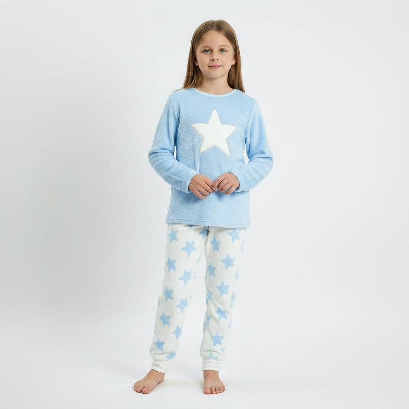Child wearing a light blue pajama set with a star design on a plain background