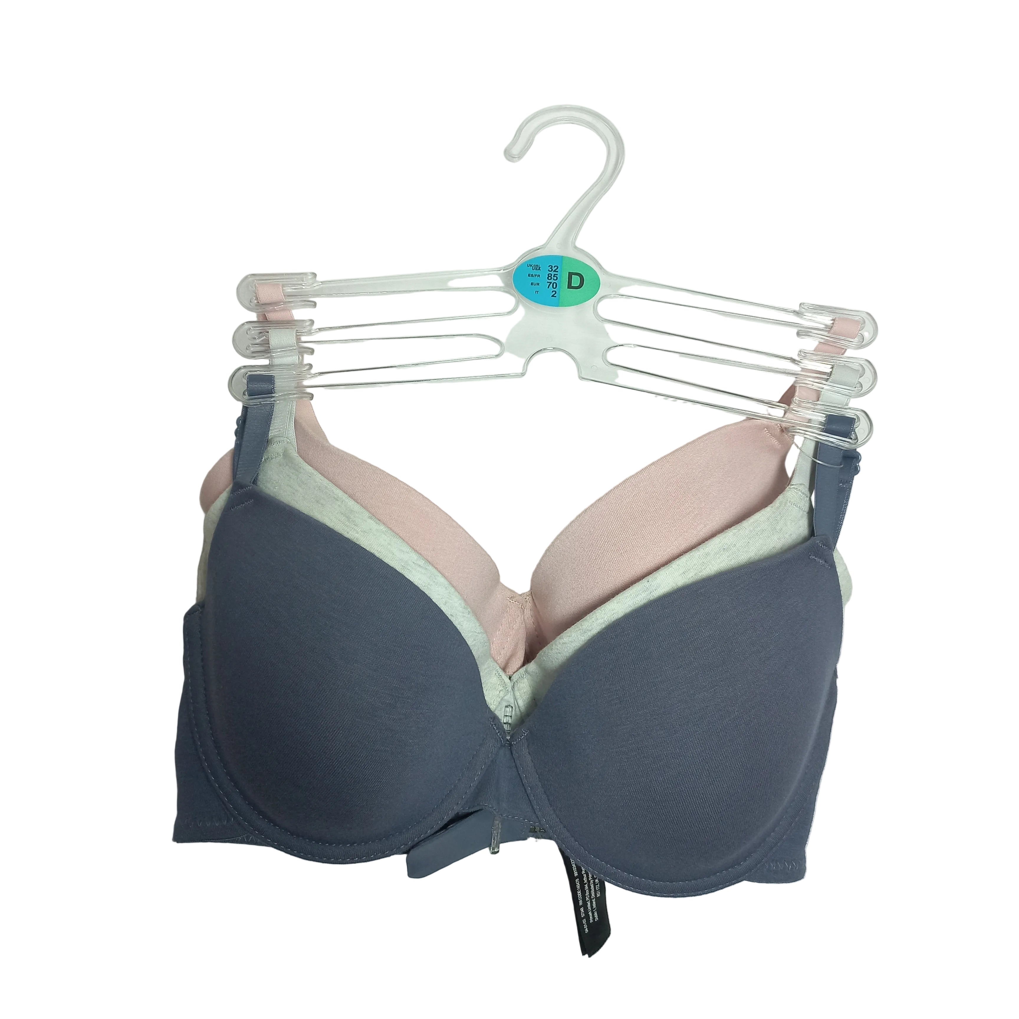 Pack of 3 t-shirts, Primark bras on a clear hanger against a white background