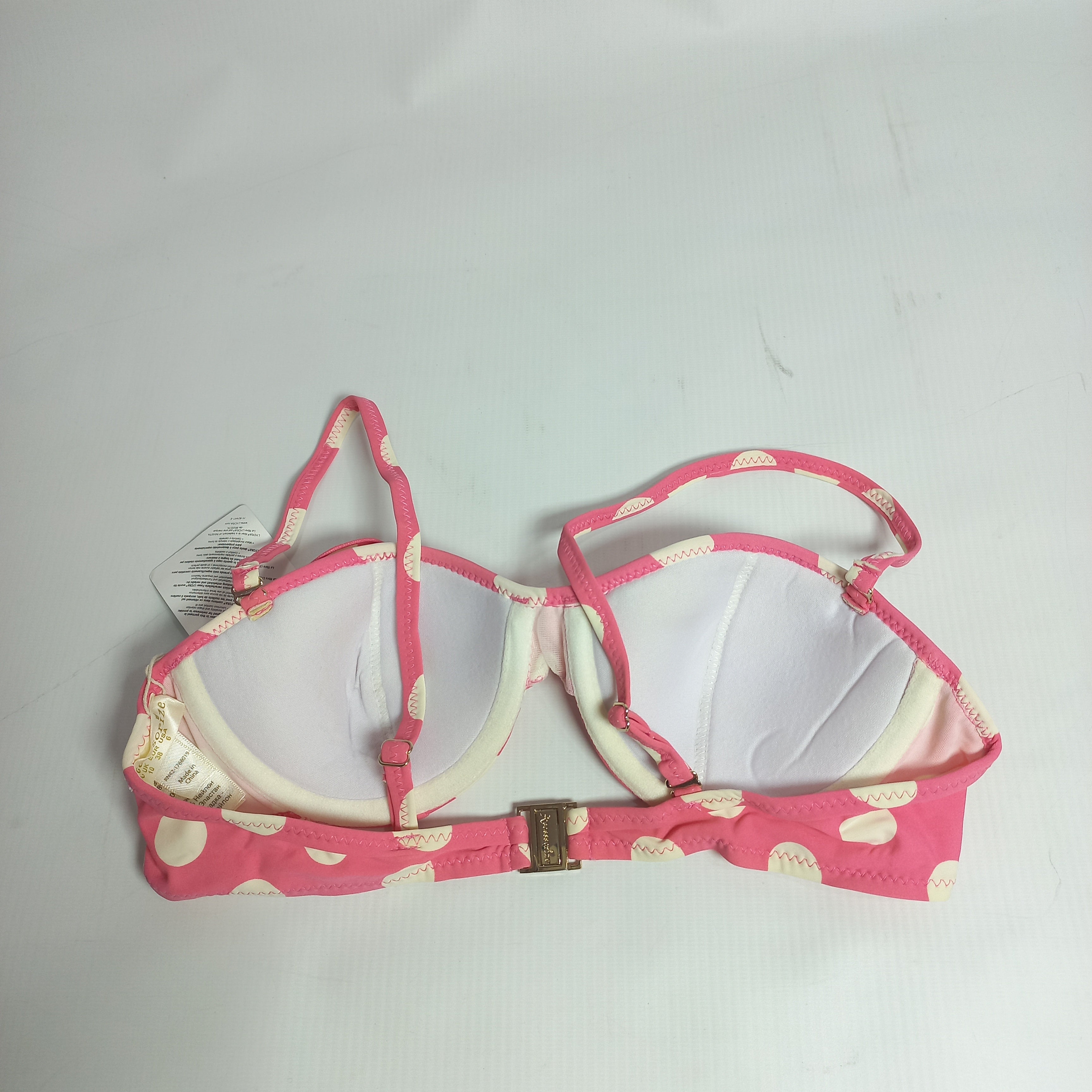 Pink bra with heart pattern on a gray background back view