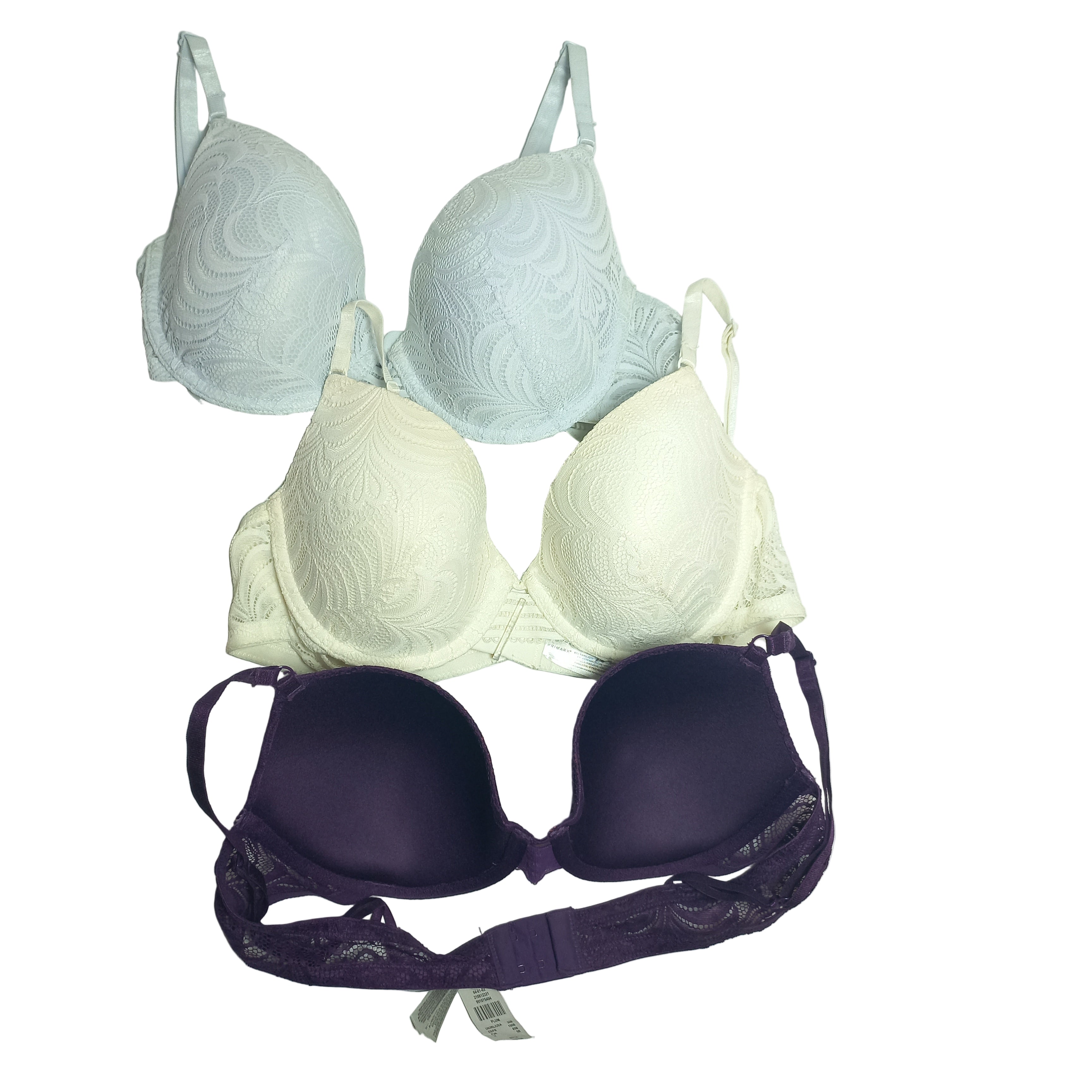 Set of three bras in different colors on a light gray background