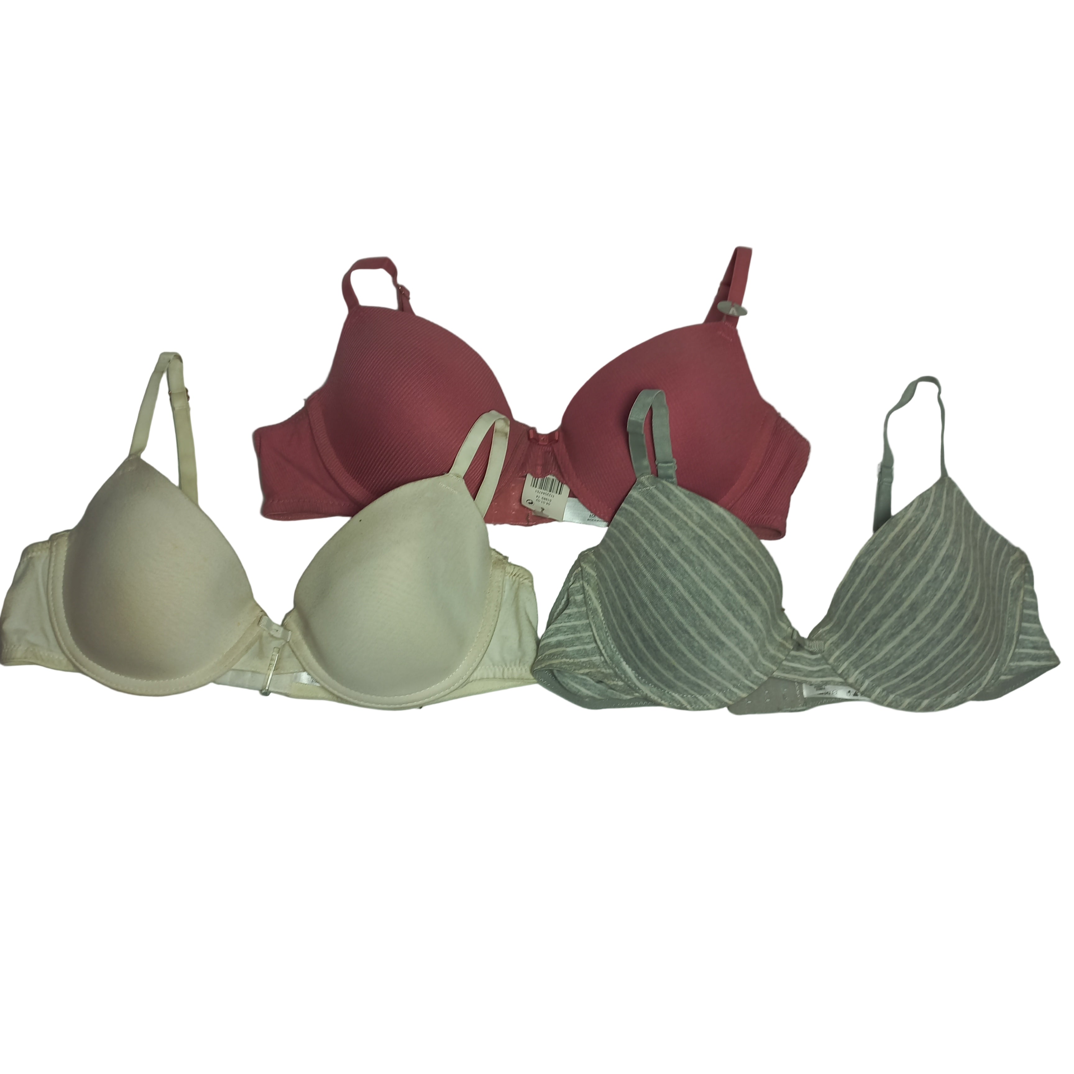 Three Primark T-Shirt bras in beige, red, and green on a white background
