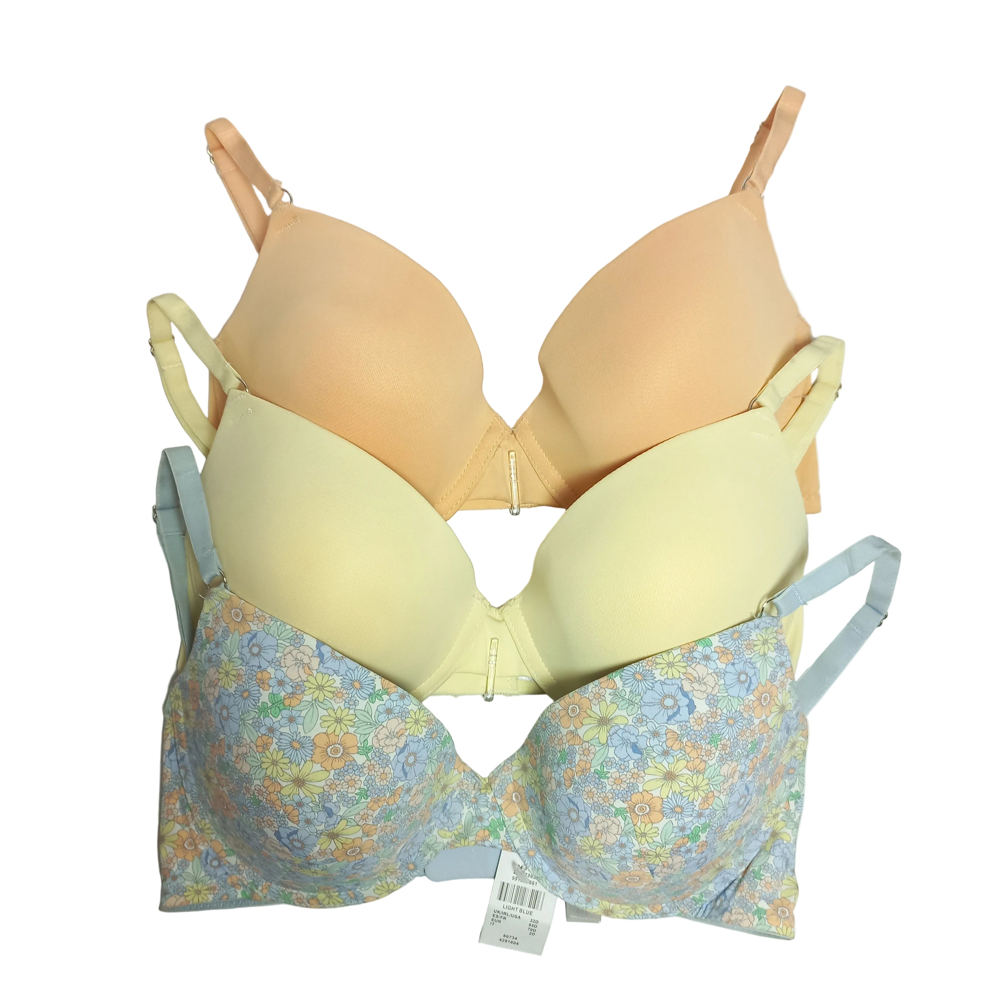 Three Primark T-shirt bras in different colors on a light gray background