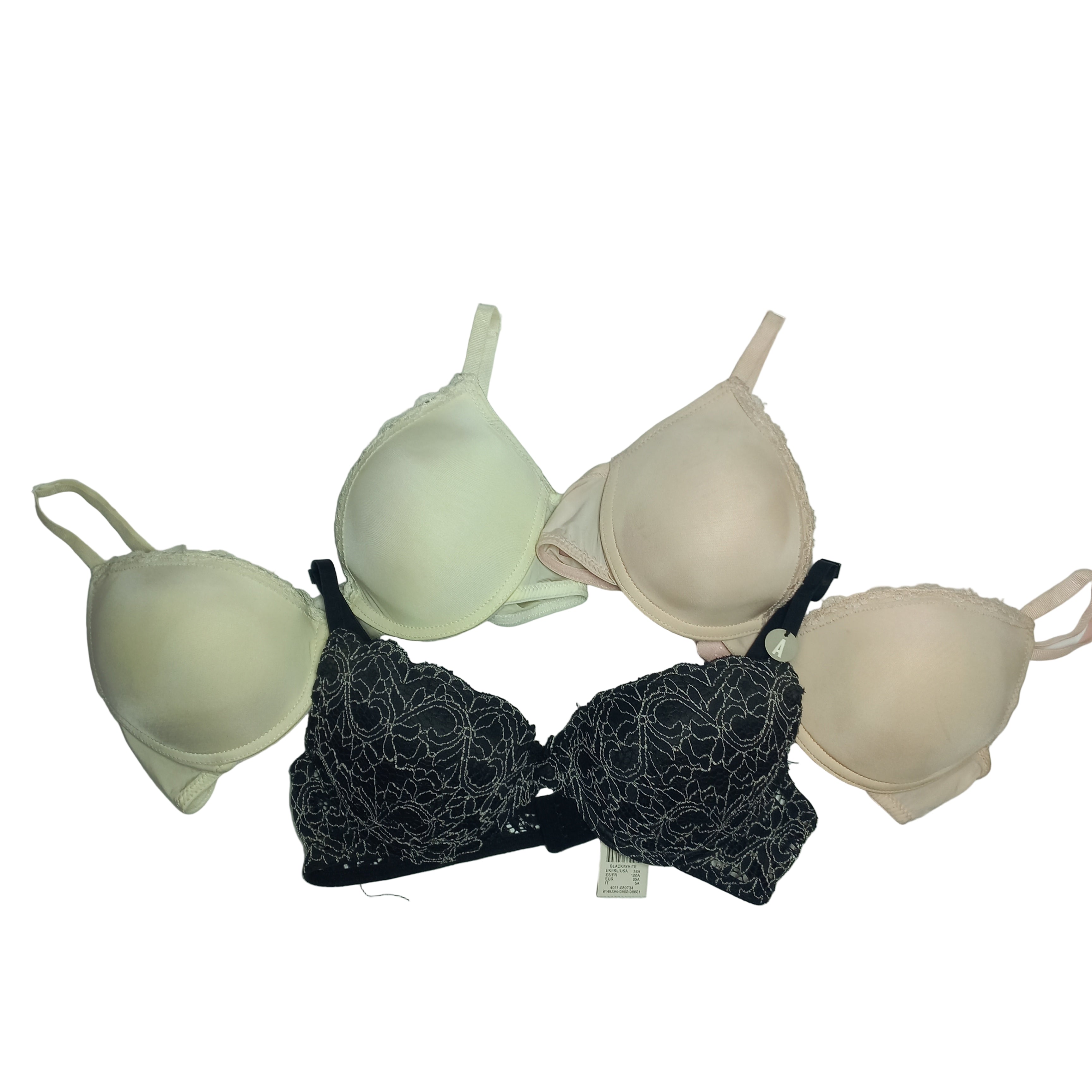 Three Primark bras in different colors hanging against a light gray background
