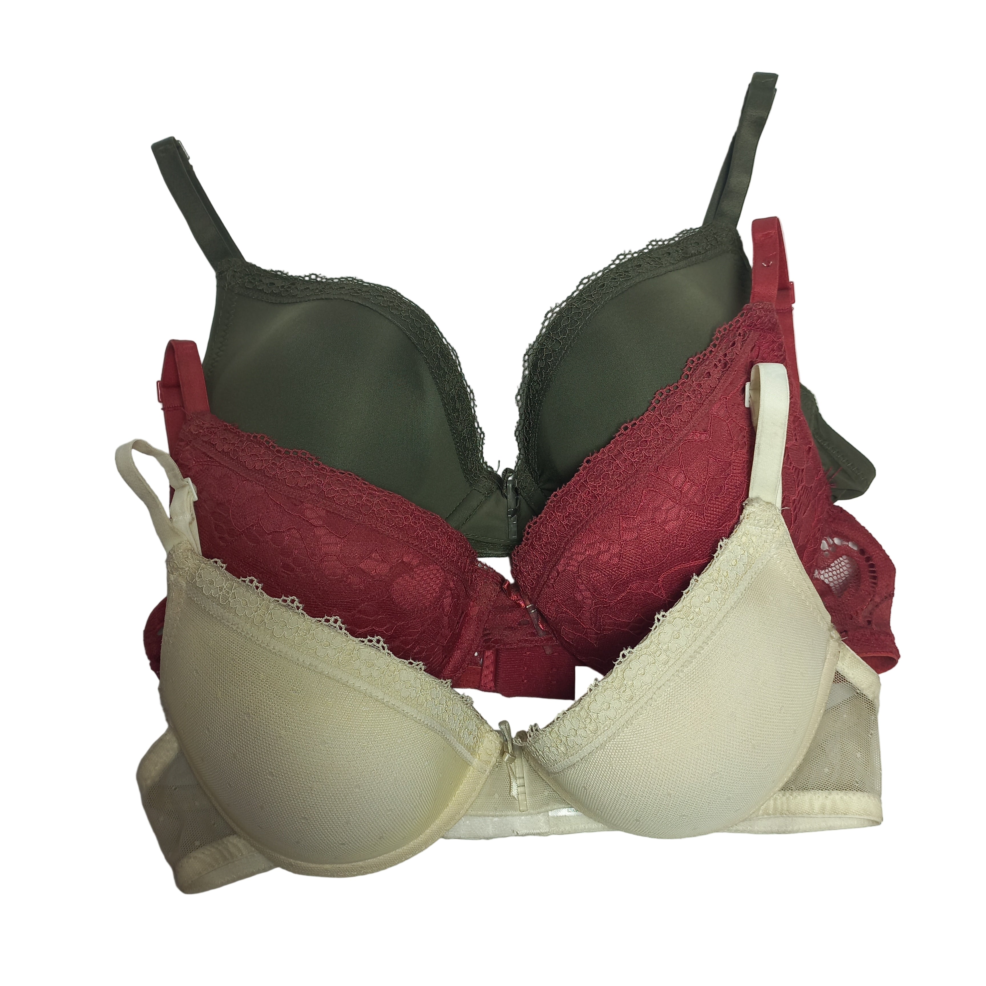 Three T-shirt bras in beige, red, and green on a light gray background