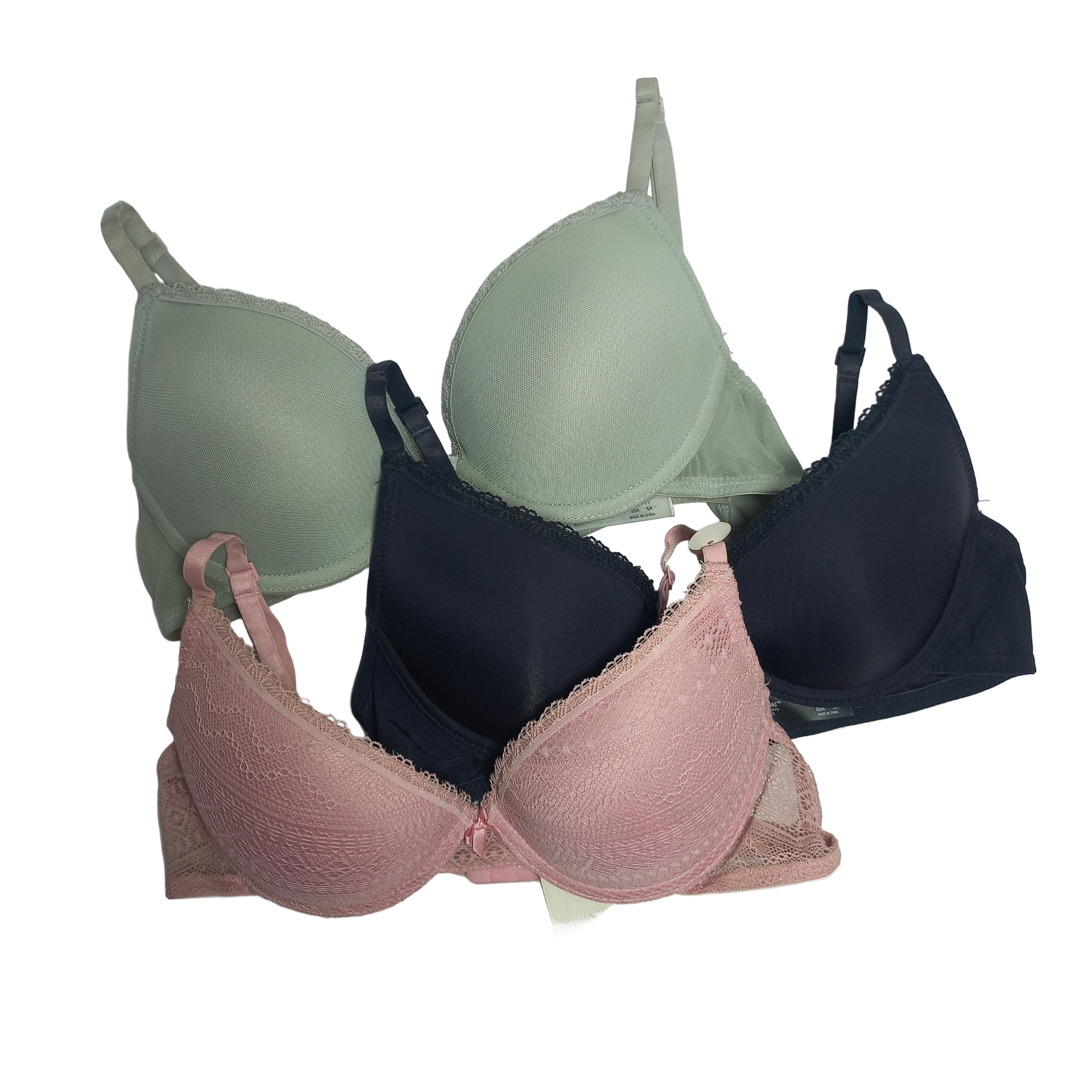 Three primark t shirt bras in black, green, and pink on a light gray background