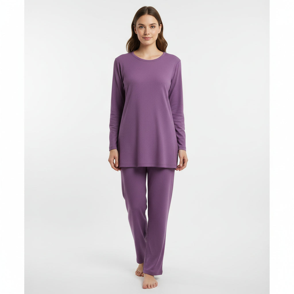 Woman wearing a purple pajama set on a white background