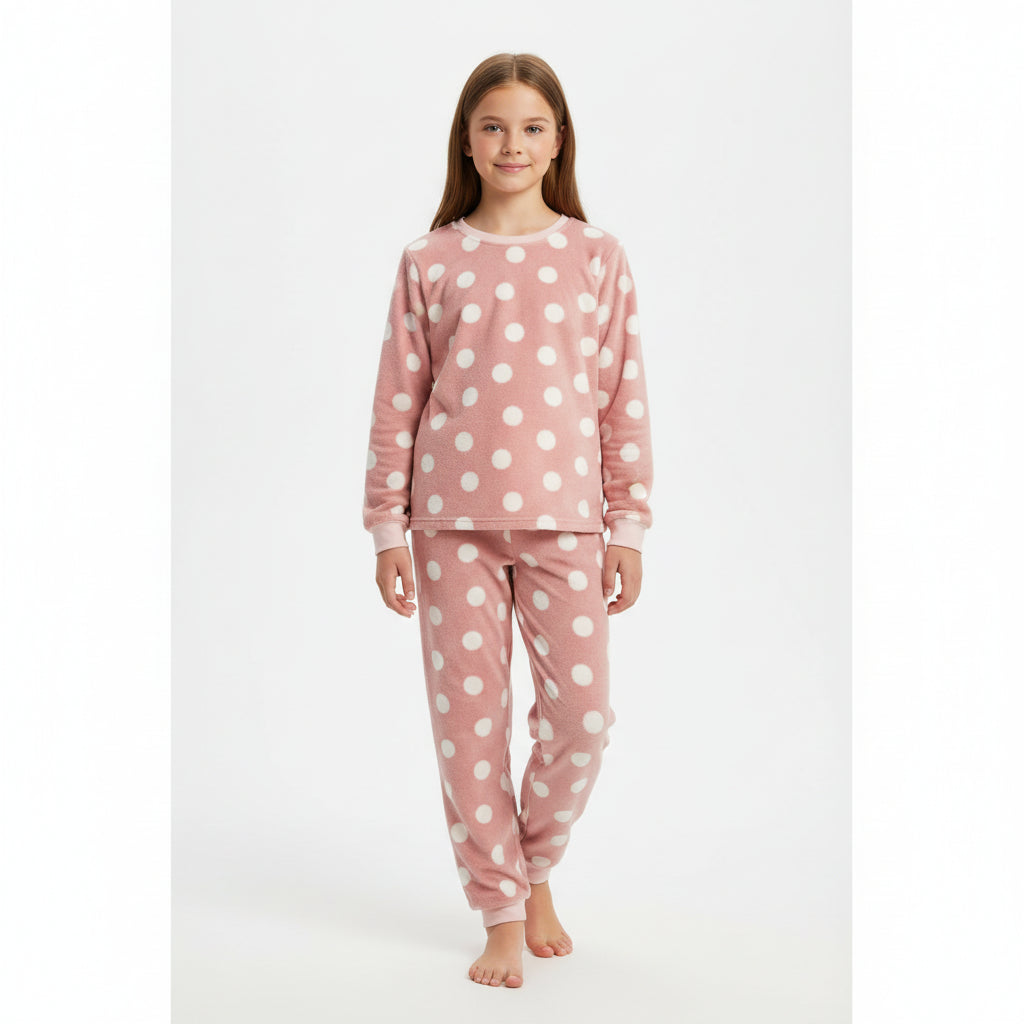 Young girl wearing pink polka dot pajamas in Pakistan